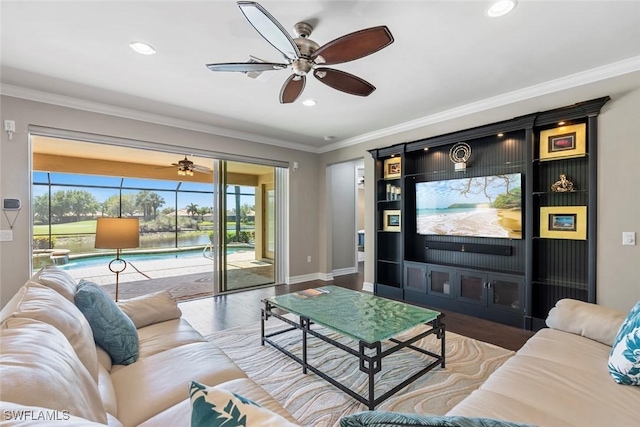 living room with recessed lighting, ornamental molding, baseboards, and wood finished floors