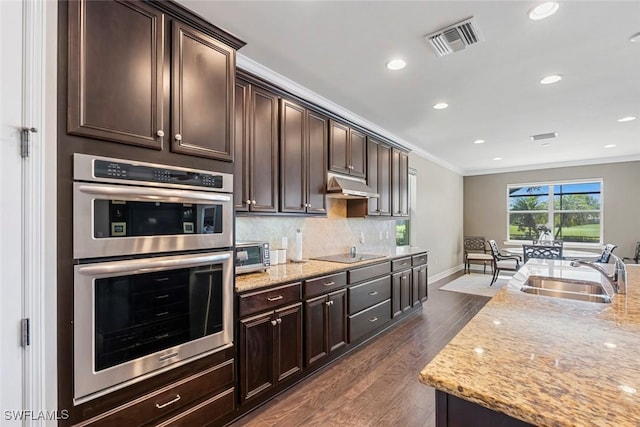 kitchen with visible vents, ornamental molding, stainless steel double oven, black electric cooktop, and a sink