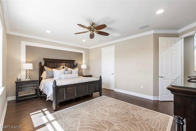 bedroom with visible vents, crown molding, baseboards, and wood finished floors