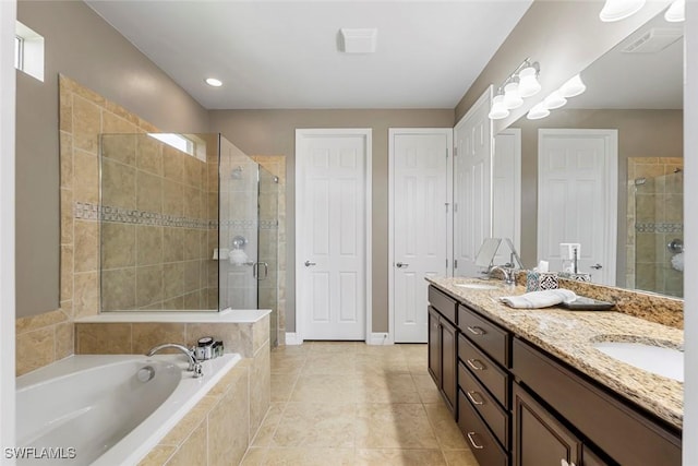 bathroom featuring a garden tub, visible vents, a stall shower, and a sink