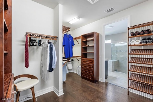 walk in closet featuring visible vents and wood finished floors