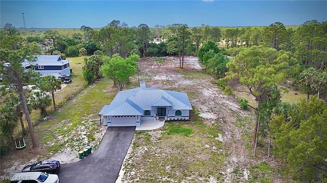 birds eye view of property featuring a view of trees