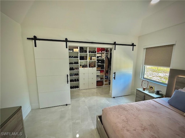 unfurnished bedroom featuring a barn door