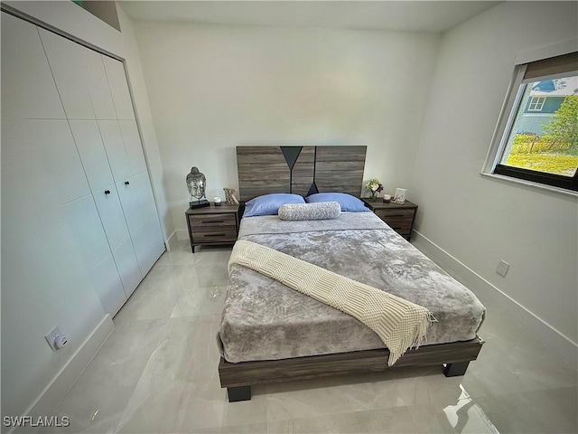 bedroom with a closet and baseboards