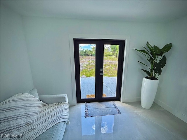 doorway to outside with french doors and baseboards