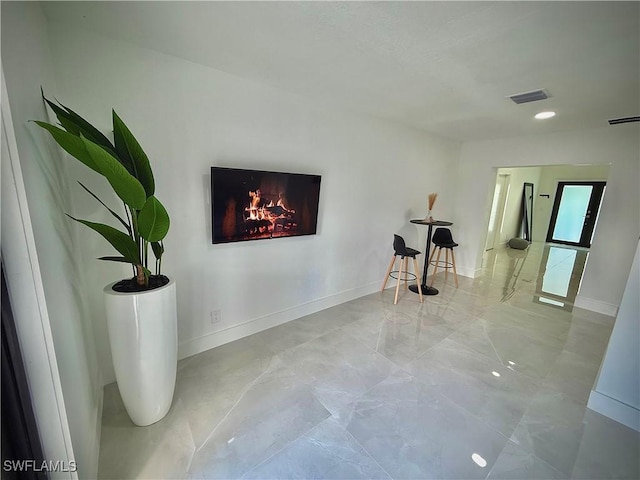 corridor featuring visible vents and baseboards