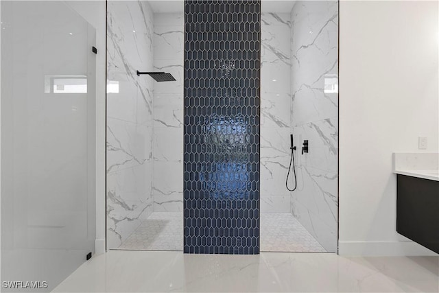 bathroom featuring a marble finish shower, baseboards, marble finish floor, and vanity