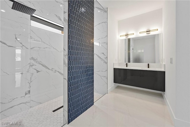 bathroom with double vanity, a marble finish shower, baseboards, and a sink