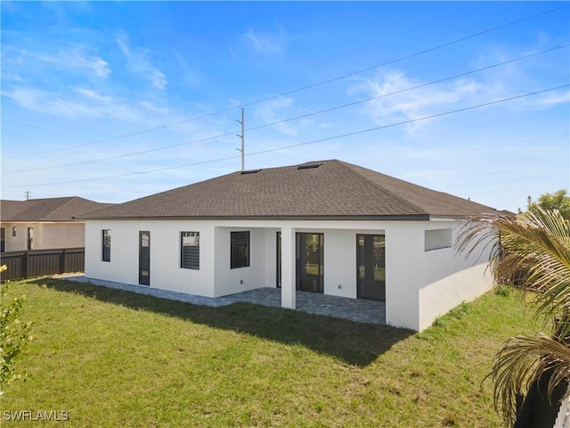 back of property featuring a patio area, stucco siding, a lawn, and fence