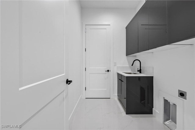 washroom featuring a sink, cabinet space, hookup for an electric dryer, and marble finish floor