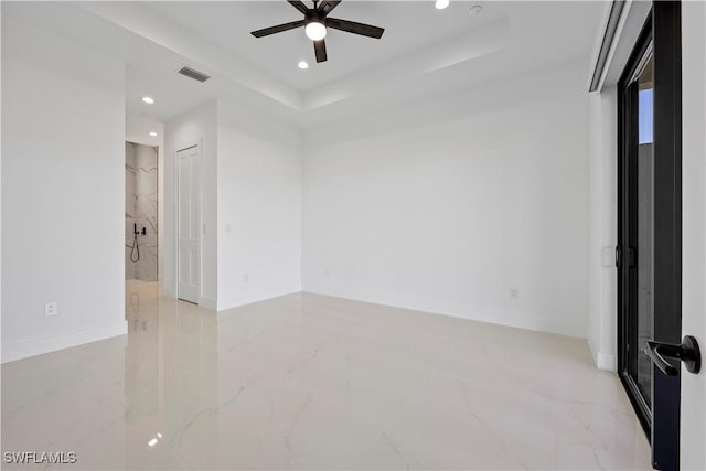 spare room with visible vents, marble finish floor, recessed lighting, a raised ceiling, and ceiling fan