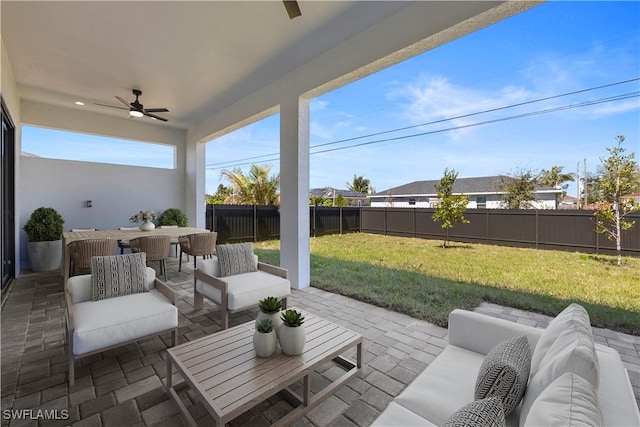 view of patio / terrace featuring an outdoor living space, ceiling fan, and a fenced backyard