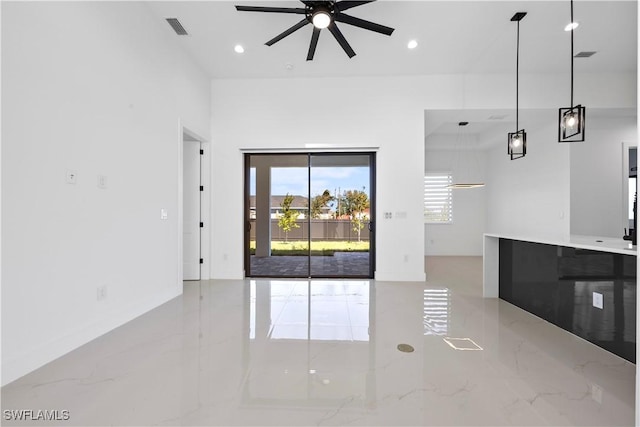 unfurnished living room with recessed lighting, visible vents, marble finish floor, and ceiling fan