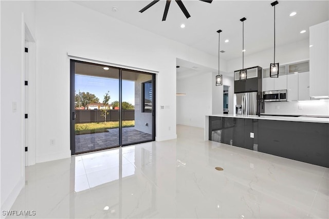 kitchen with decorative light fixtures, light countertops, recessed lighting, stainless steel appliances, and modern cabinets