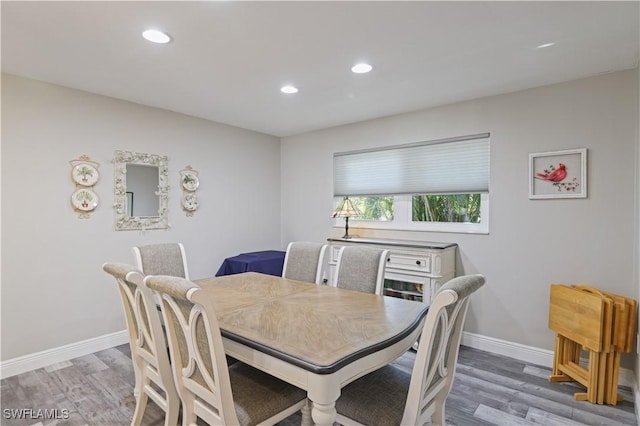 dining room with recessed lighting, baseboards, and light wood finished floors