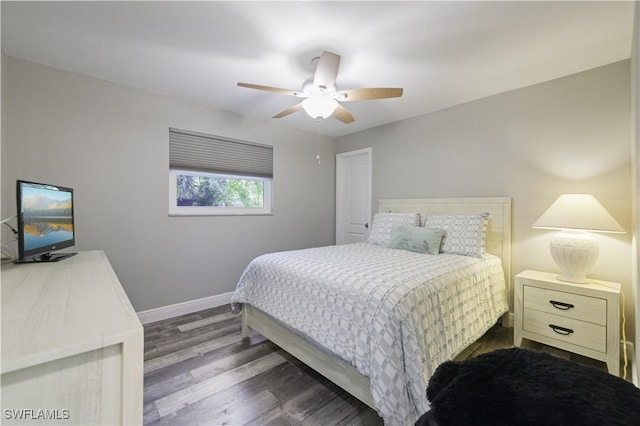 bedroom featuring wood finished floors, baseboards, and ceiling fan