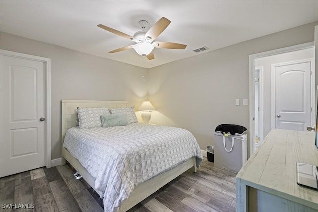 bedroom with visible vents, baseboards, and wood finished floors