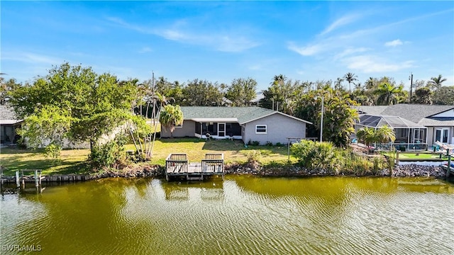 dock area featuring a yard and a water view