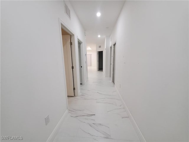 hall with recessed lighting, visible vents, marble finish floor, and baseboards