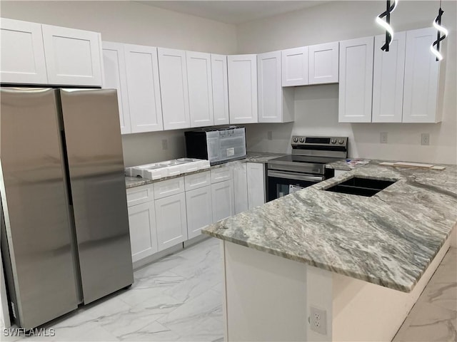 kitchen featuring stainless steel appliances, marble finish floor, a peninsula, and white cabinetry