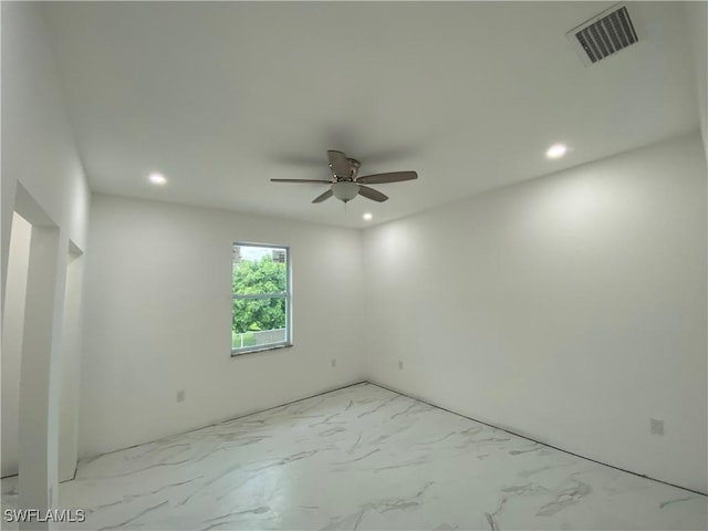 spare room featuring a ceiling fan, recessed lighting, visible vents, and marble finish floor