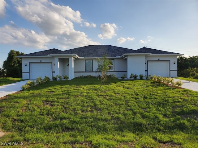 view of front of home with concrete driveway, stucco siding, a garage, and a front lawn