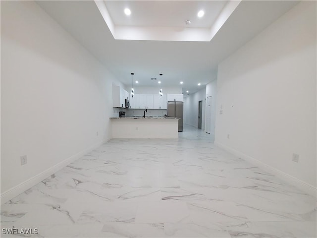 unfurnished living room with recessed lighting, marble finish floor, and baseboards