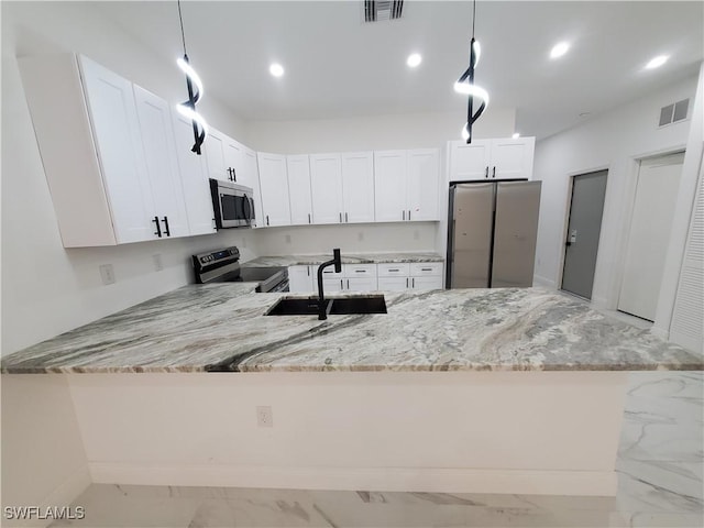 kitchen featuring visible vents, marble finish floor, a sink, appliances with stainless steel finishes, and a peninsula