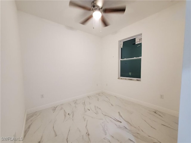 unfurnished room featuring baseboards, marble finish floor, and ceiling fan