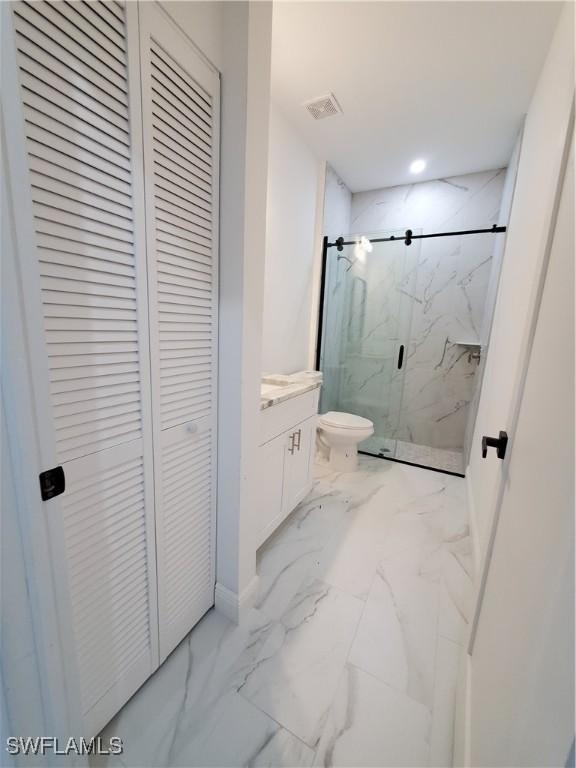 full bath featuring visible vents, a marble finish shower, a closet, toilet, and marble finish floor