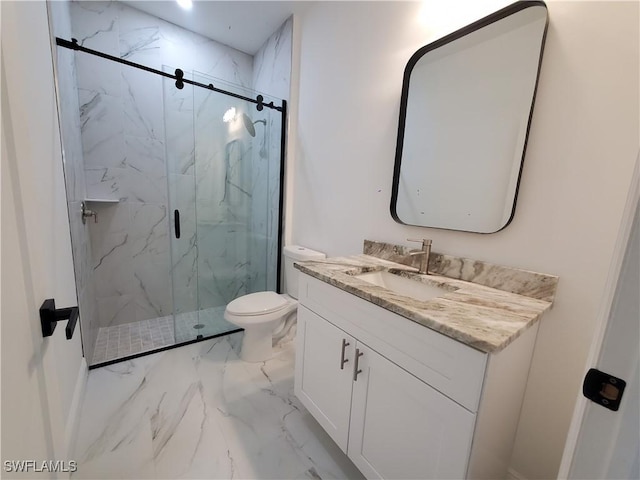 bathroom featuring vanity, toilet, marble finish floor, and a marble finish shower