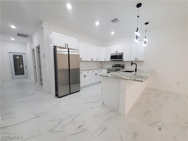 kitchen featuring a sink, visible vents, appliances with stainless steel finishes, and a peninsula