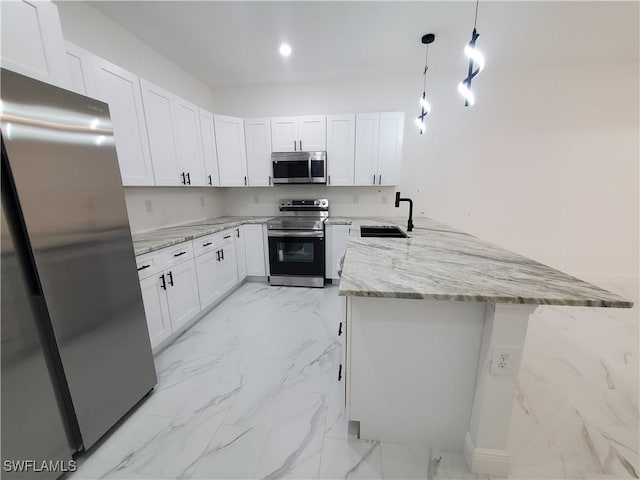 kitchen with appliances with stainless steel finishes, a peninsula, marble finish floor, white cabinetry, and a sink