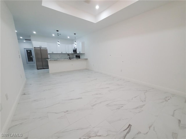 interior space featuring recessed lighting, marble finish floor, and baseboards