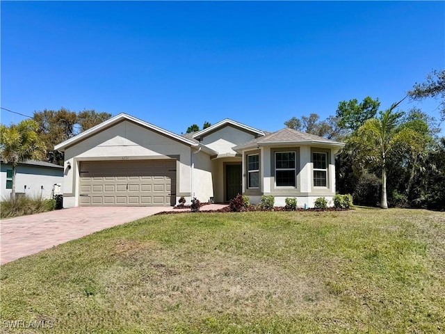 ranch-style house featuring a garage, stucco siding, decorative driveway, and a front lawn