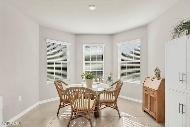 dining room featuring light tile patterned floors and baseboards