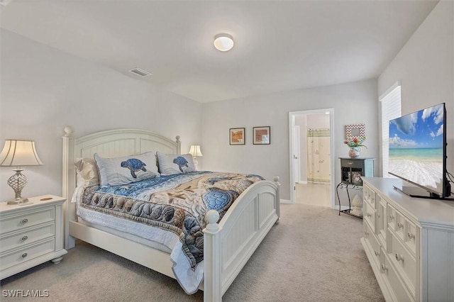 bedroom with visible vents and light carpet