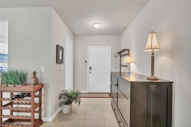 entrance foyer with light tile patterned floors and baseboards