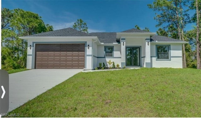 prairie-style house with a front yard, a garage, driveway, and stucco siding