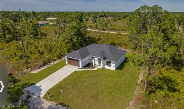 drone / aerial view featuring a forest view