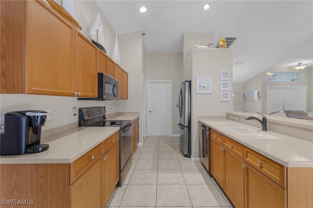 kitchen featuring a sink, black appliances, a peninsula, and light countertops