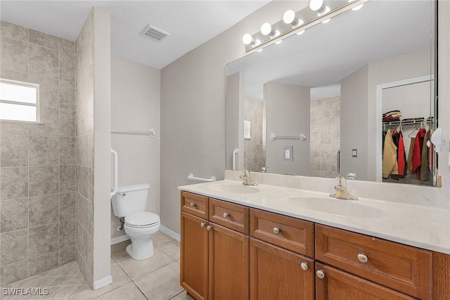 full bathroom with a sink, visible vents, double vanity, and tile patterned floors