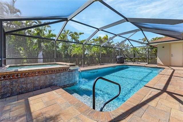 view of pool featuring a patio, a pool with connected hot tub, and a lanai