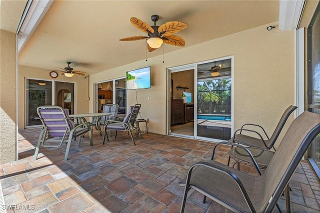 view of patio with outdoor dining space and ceiling fan