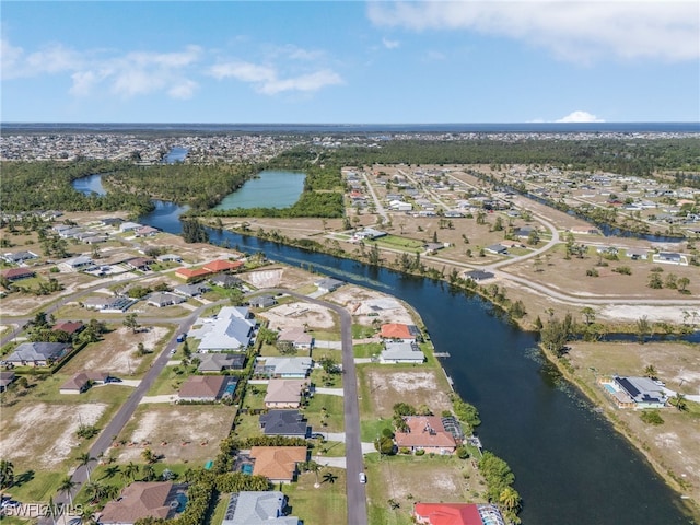 birds eye view of property with a residential view and a water view