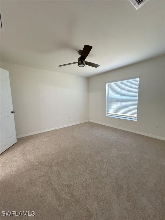 empty room featuring visible vents, baseboards, ceiling fan, and carpet floors