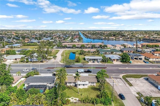 drone / aerial view with a residential view and a water view