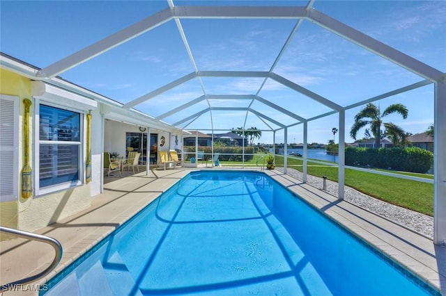 outdoor pool with a yard, a water view, a lanai, and a patio area