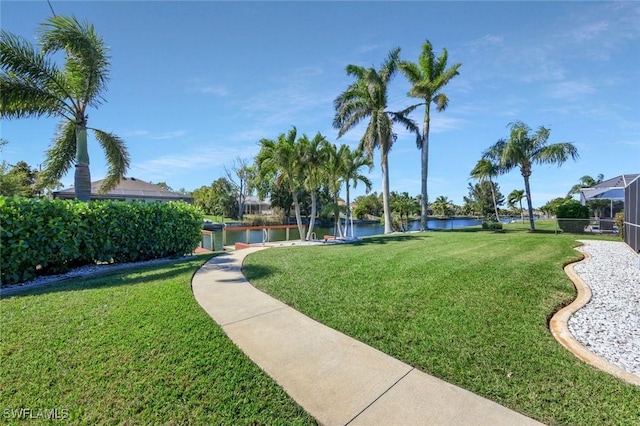 view of community with a lawn and a water view