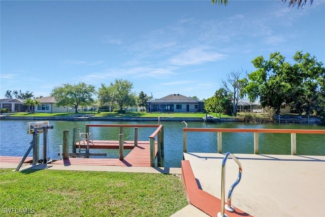 dock area with a yard and a water view